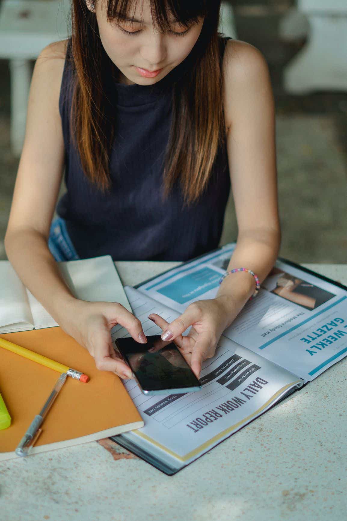 student checking her phone